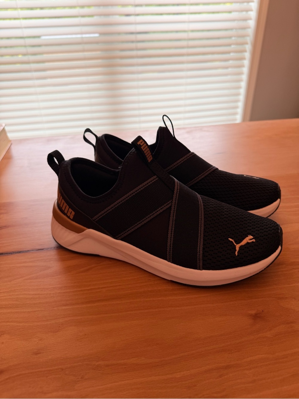 Puma Black Slip-On Athletic Sneakers with White Midsole and Gold Accents